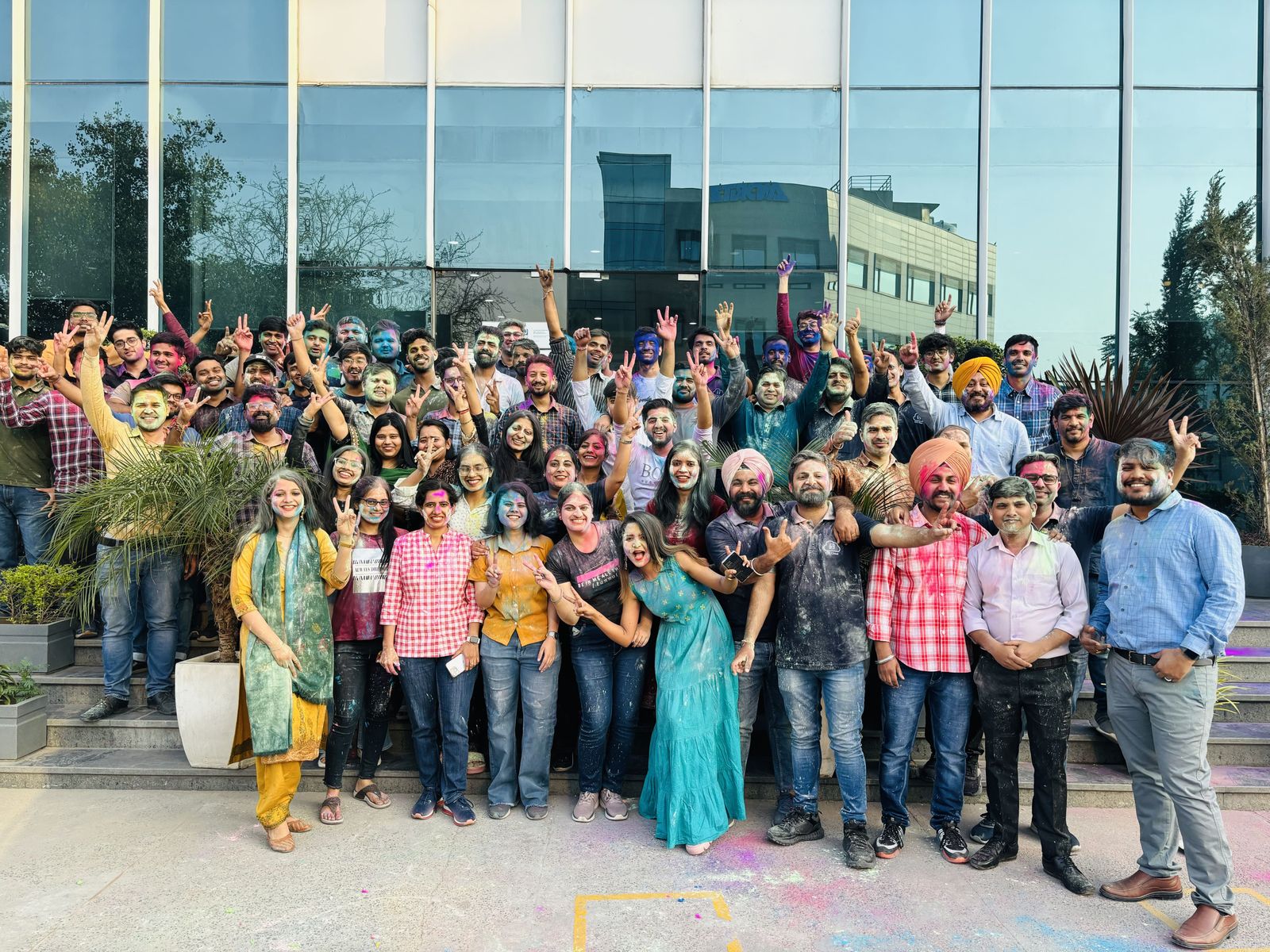 E2E Networks team celebrating together with colorful festivities